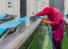 IMSORB Industriereiniger im Einsatz zur Reinigung von Förderband und Maschinen in Produktionsumgebung